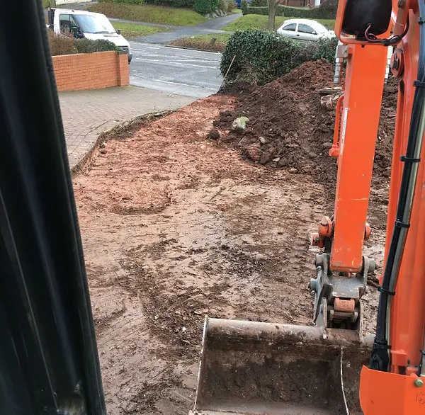 Excavating during a driveway project with help from our Hitachi 2.2u